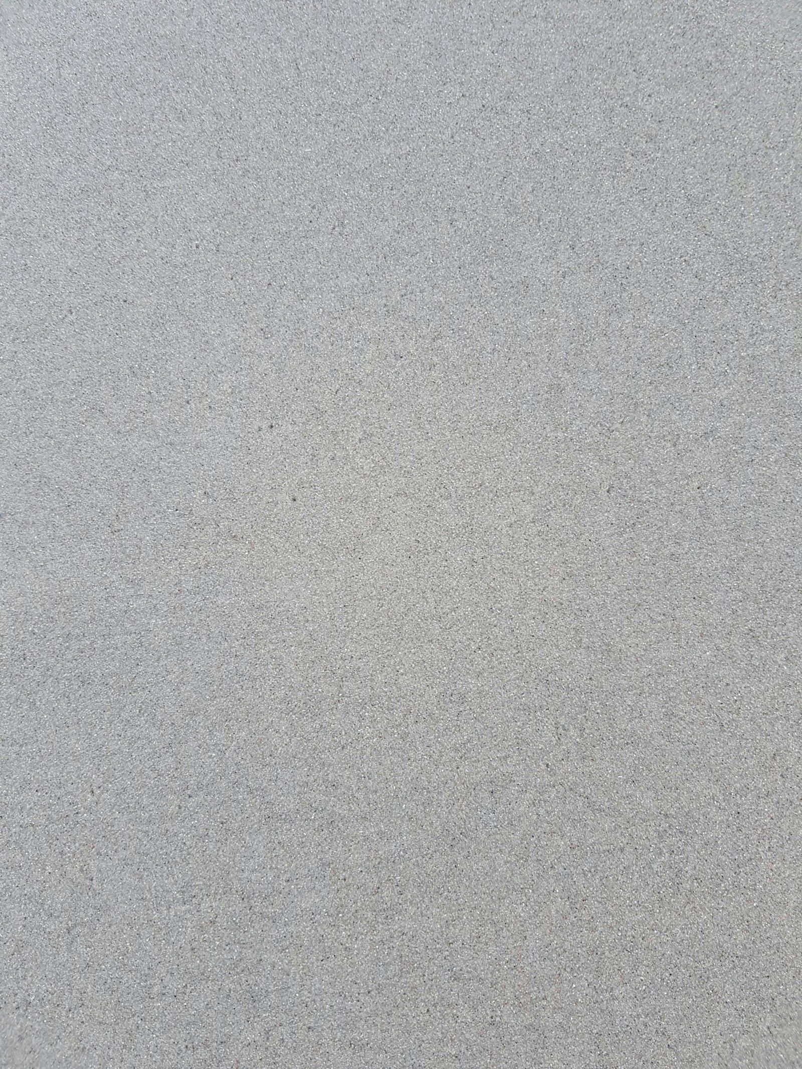 Yakından çekilmiş gri renkli ince elenmiş sıva kumu dokusu